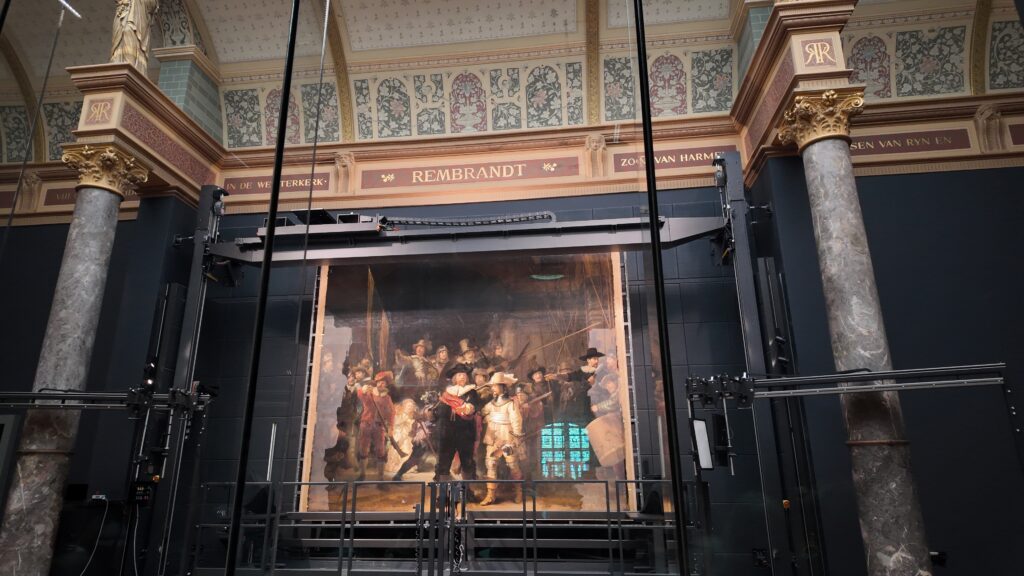 Rembrandt's The Night Watch behind the protective screen at the Rijksmuseum. 